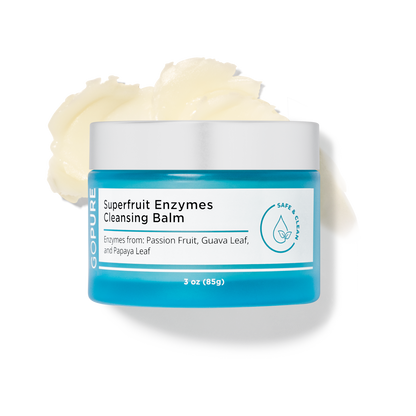 Open jar of GoPure Superfruit Enzymes Cleansing Balm with a creamy texture visible, labeled with ingredients like passion fruit, guava leaf, and papaya leaf in a 3 oz container.