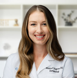 Doctor Jessica wearing a white medical coat with a nametag that reads "Dermatology."