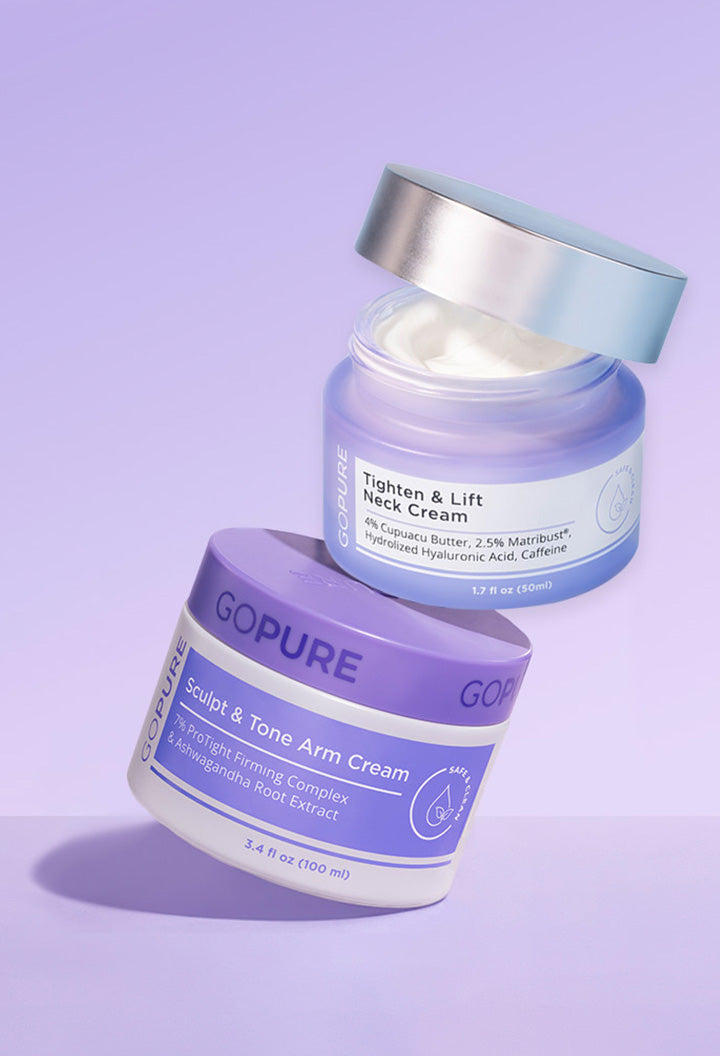 
Two skincare product jars from the brand "GOPURE" on a lavender background. The upper jar is labeled "Tighten & Lift Neck Cream" with a metallic lid slightly open, showing white cream inside. The lower jar is labeled "Sculpt & Tone Arm Cream" with a purple lid and white container. Both feature clean, modern packaging.