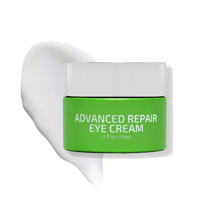 Green jar of 'ADVANCED REPAIR EYE CREAM' with a white lid, against a pure white background with a creamy texture spill on one side.