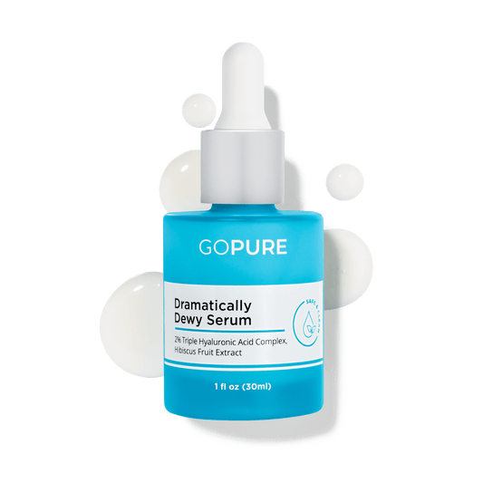 GoPure Dramatically Dewy Serum in a blue bottle with dropper, surrounded by droplets, indicating hydration with 2% Hyaluronic Acid and Hibiscus Extract, 1 fl oz.