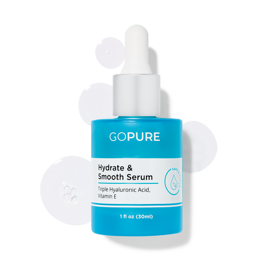 GoPure’s Hydrate & Smooth Serum in a blue bottle with white dropper displayed with serum drops around it. Ingredients include Triple Hyaluronic Acid and Vitamin E. 1 fl oz.