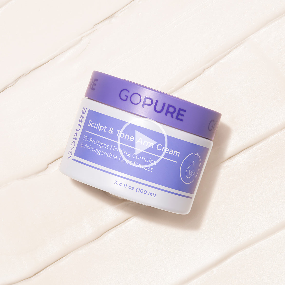 Jar of “GOPURE Sculpt & Tone Arm Cream” placed on a creamy textured background, showing the product’s label with key ingredients and a play button overlay suggesting video content.