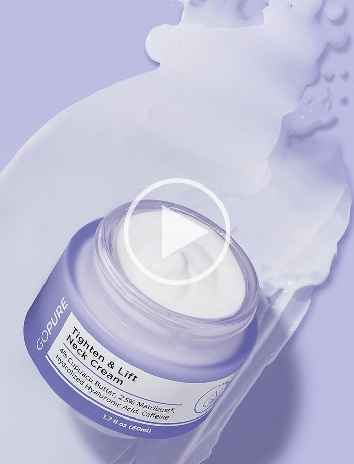 GoPure Tighten & Lift Neck Cream in an open purple jar with cream spilled around it on a purple surface. The label highlights 4% Cupuacu Butter, 2.5% Matrixyl®, Hydrolyzed Hyaluronic Acid, and Caffeine.