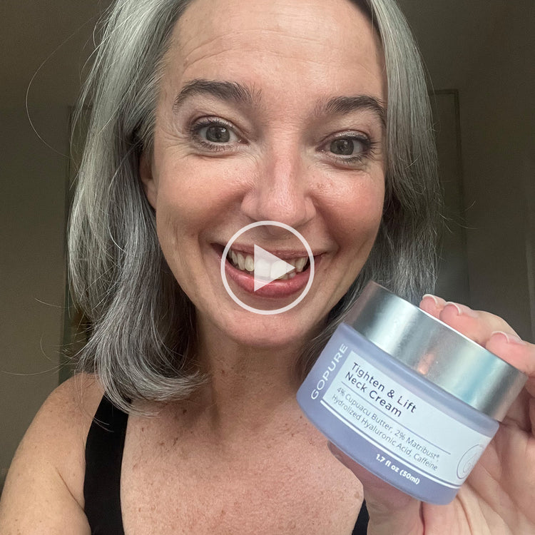 Smiling woman with gray hair holding a jar of GoPure Tighten & Lift Neck Cream. The jar label highlights 4% Cupuacu Butter, 2.5% Matrixyl®, Hydrolyzed Hyaluronic Acid, and Caffeine. Play button overlay indicates this is a video thumbnail.