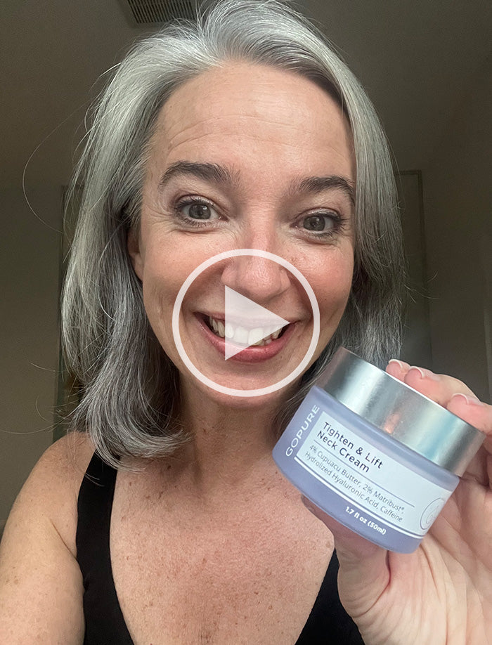 Smiling woman with gray hair holding a jar of GoPure Tighten & Lift Neck Cream. The jar label highlights 4% Cupuacu Butter, 2.5% Matrixyl®, Hydrolyzed Hyaluronic Acid, and Caffeine. Play button overlay indicates this is a video thumbnail.
